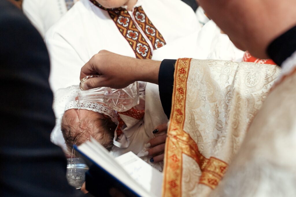 baptism baby. cute little feet of a girl at christening in church